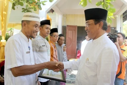Bupati Inhil Drs HM Wardan MP saat menyerahkan penghargaan BAZDA Inhil kepada Disdik sebagai intansi penyalur Zakat terbanyak PNS
